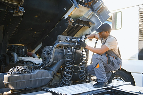 Mechanic servicing jake brake components on a heavy duty truck