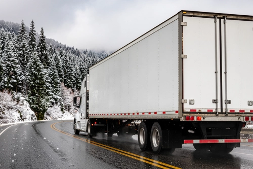 Truck using engine brake on a wet mountain highway in winter